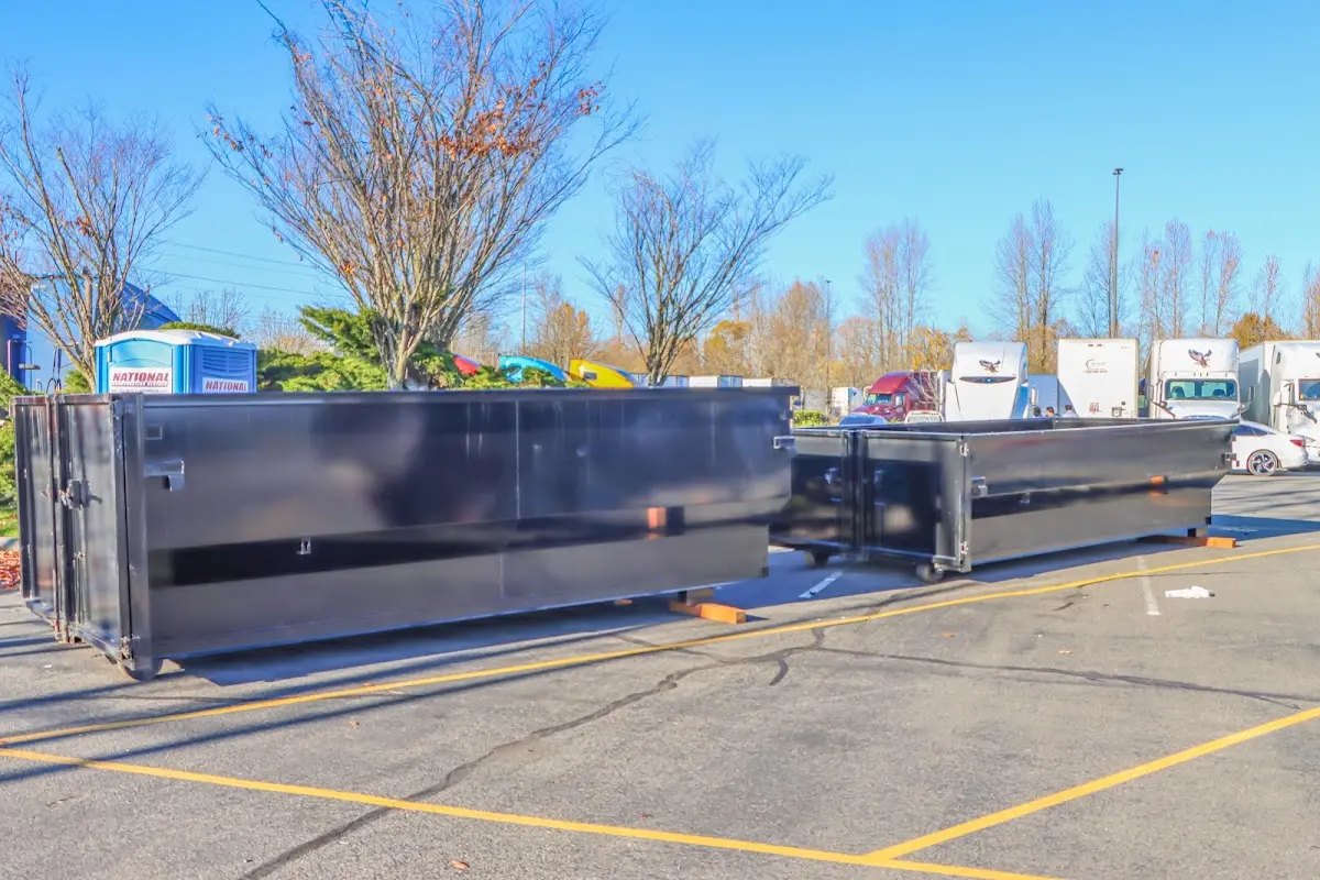 Professional dumpster rental service with roll-off container on residential driveway in Kalifornsky